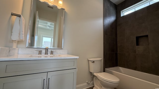 bathroom with toilet, vanity, and baseboards