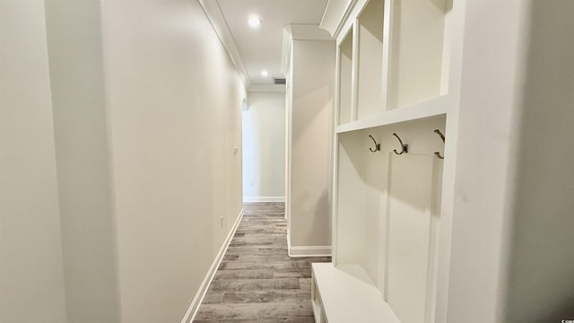 mudroom featuring wood finished floors, baseboards, recessed lighting, and crown molding