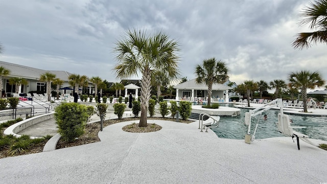 view of home's community featuring a pool and a patio