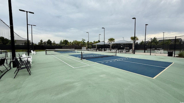 view of tennis court featuring community basketball court