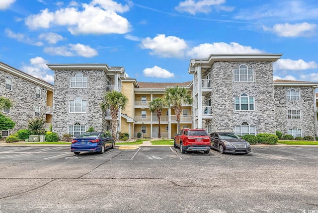 4705 Wild Iris Dr Unit 305, Myrtle Beach, SC 29577 - view of apartment building / complex featuring uncovered parking