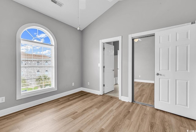 4705 Wild Iris Dr Unit 305, Myrtle Beach, SC 29577 - unfurnished bedroom featuring vaulted ceiling, light wood-style floors, multiple windows, baseboards, and a ceiling fan