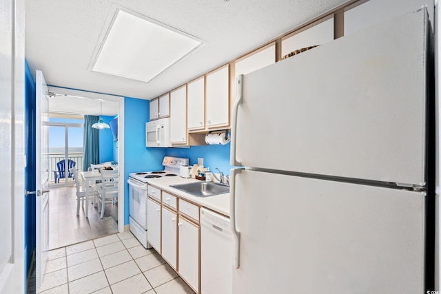 2801 S Ocean Blvd Unit 1634, North Myrtle Beach, SC 29582 - kitchen featuring white appliances, a sink, light countertops, light tile patterned flooring, and white cabinetry