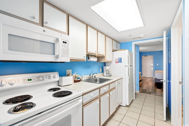 2801 S Ocean Blvd Unit 1634, North Myrtle Beach, SC 29582 - kitchen featuring white appliances, a sink, light tile patterned floors, light countertops, and white cabinets