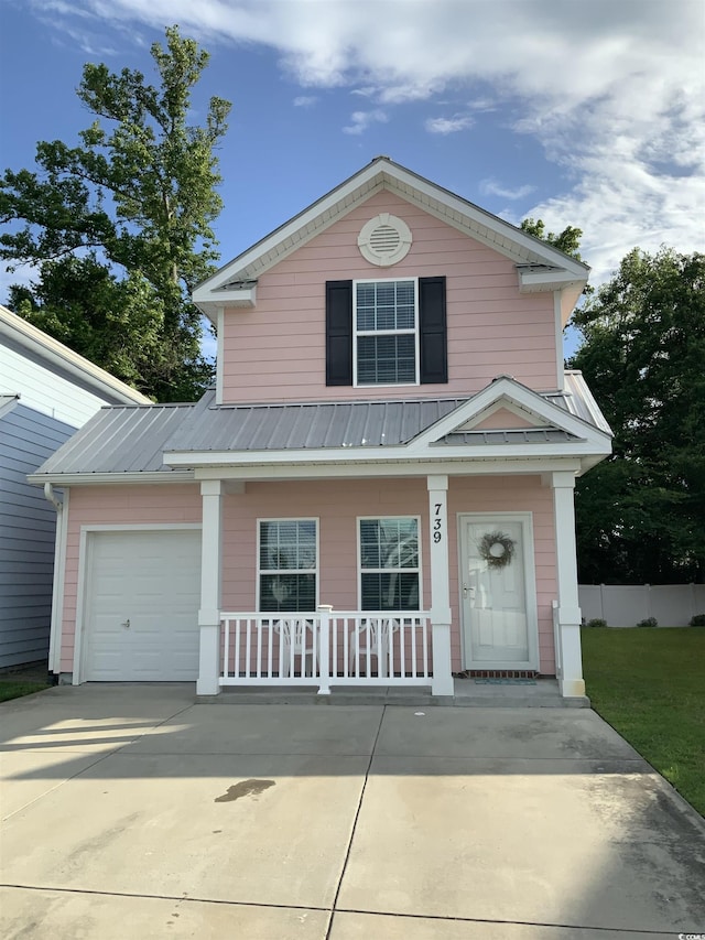 739 Shell Creek Cir Unit 739, North Myrtle Beach, SC 29582 - view of front of house featuring covered porch, concrete driveway, metal roof, a garage, and fence