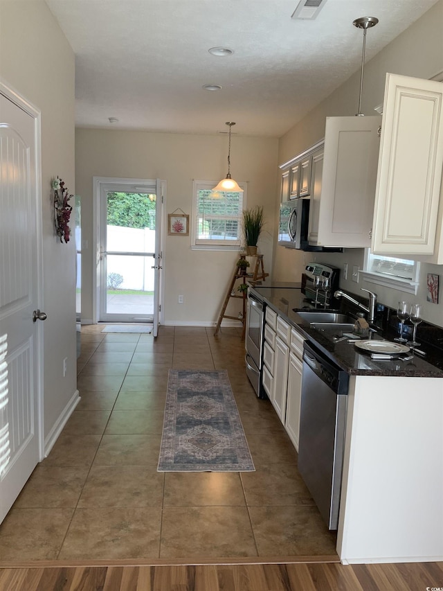 739 Shell Creek Cir Unit 739, North Myrtle Beach, SC 29582 - kitchen with appliances with stainless steel finishes, dark countertops, white cabinetry, and tile patterned flooring