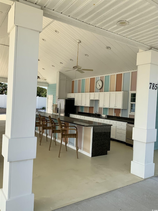739 Shell Creek Cir Unit 739, North Myrtle Beach, SC 29582 - kitchen featuring dark countertops, finished concrete flooring, ceiling fan, white cabinets, and appliances with stainless steel finishes