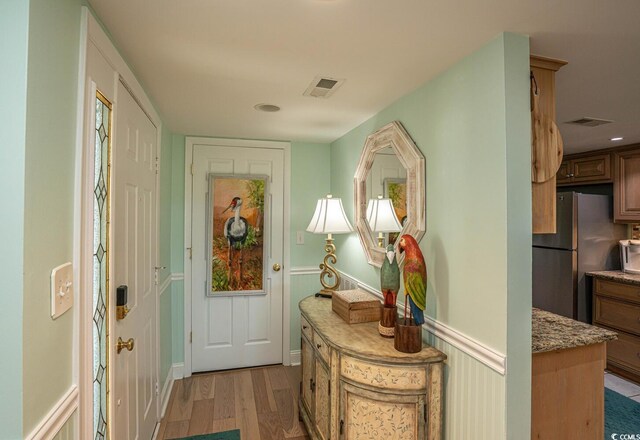 4440 Nassau Ct Unit 308, Little River, SC 29566 - foyer entrance with light wood finished floors and a wainscoted wall