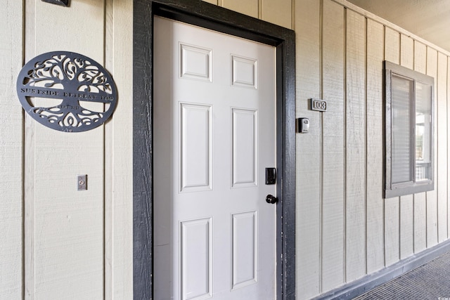 view of exterior entry with board and batten siding