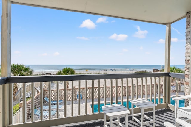 balcony featuring a water view and view of pool area