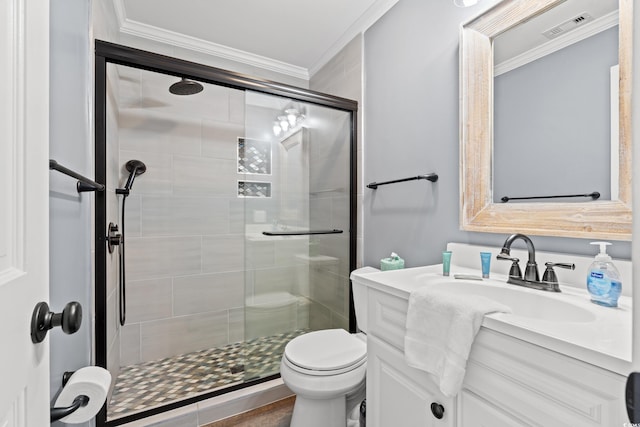 full bathroom featuring a stall shower, crown molding, toilet, and vanity