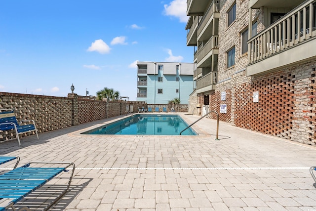 community pool with a patio area