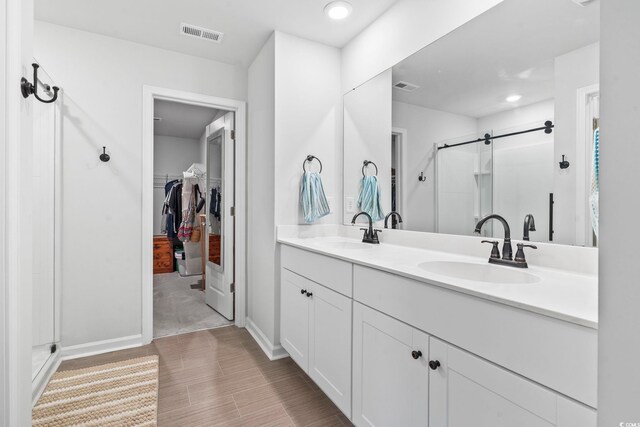 205 Marsh Deer Pl, Surfside Beach, SC 29575 - full bathroom featuring a stall shower, a spacious closet, double vanity, baseboards, and recessed lighting