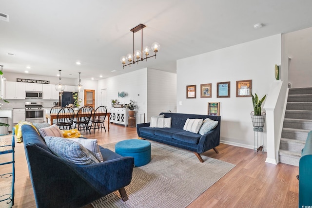 205 Marsh Deer Pl, Surfside Beach, SC 29575 - living room with recessed lighting, light wood-style floors, stairs, baseboards, and a chandelier
