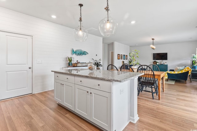 205 Marsh Deer Pl, Surfside Beach, SC 29575 - kitchen featuring a center island, light wood-style flooring, decorative light fixtures, light stone countertops, and recessed lighting