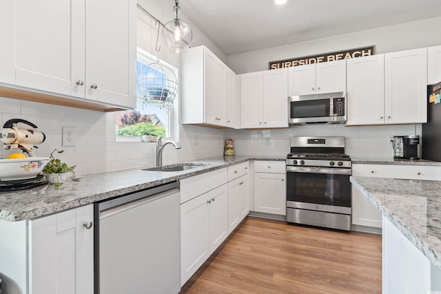 205 Marsh Deer Pl, Surfside Beach, SC 29575 - kitchen featuring stainless steel appliances, a sink, white cabinets, and tasteful backsplash