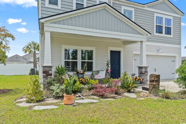 205 Marsh Deer Pl, Surfside Beach, SC 29575 - craftsman-style house with board and batten siding, a garage, a porch, and central AC unit