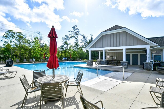 1141 Prescott Cir, Myrtle Beach, SC 29577 - community pool featuring a patio area and an outbuilding