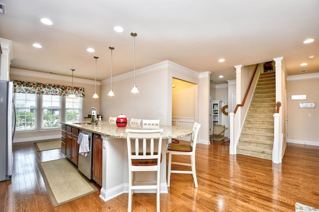 1141 Prescott Cir, Myrtle Beach, SC 29577 - kitchen featuring a sink, appliances with stainless steel finishes, a kitchen island with sink, light wood-type flooring, and ornamental molding
