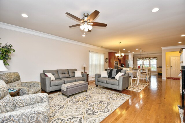 1141 Prescott Cir, Myrtle Beach, SC 29577 - living area with crown molding, a chandelier, a ceiling fan, light wood-style flooring, and recessed lighting