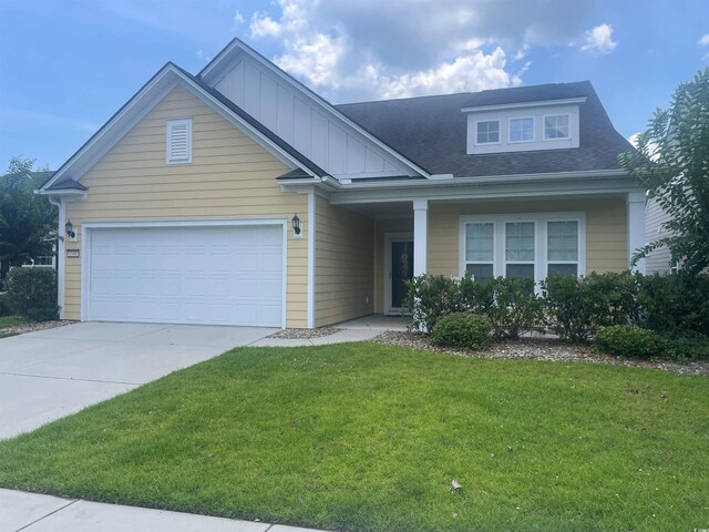 1141 Prescott Cir, Myrtle Beach, SC 29577 - view of front of house with a garage, a front lawn, driveway, and roof with shingles