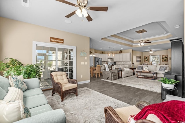 413 Wine Ct, Conway, SC 29527 - living room with ceiling fan, dark wood-style flooring, ornamental molding, a tray ceiling, and baseboards