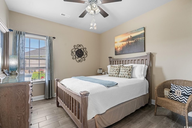 bedroom with wood finish floors, baseboards, and a ceiling fan