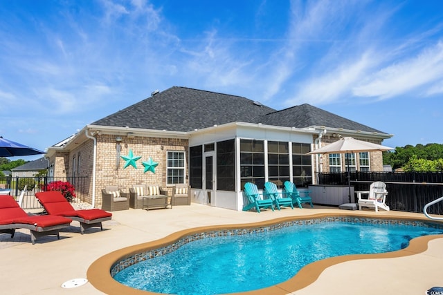 view of pool with a patio, an outdoor hangout area, a sunroom, and a hot tub