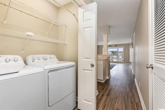 4633 Lightkeepers Way Unit 5-F, Little River, SC 29566 - laundry area featuring independent washer and dryer, dark wood finished floors, ornate columns, and baseboards