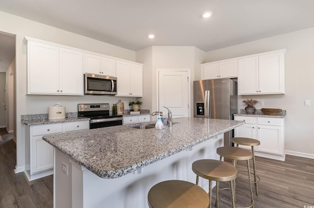 2859 Riverboat Way, Conway, SC 29526 - kitchen featuring appliances with stainless steel finishes, a sink, baseboards, dark wood-style floors, and white cabinetry