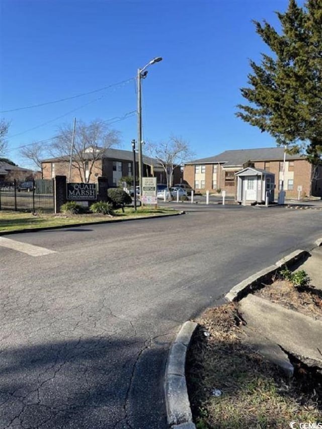 2005 Greens Blvd Unit F-205, Myrtle Beach, SC 29577 - view of asphalt road with street lights, curbs, and a residential view