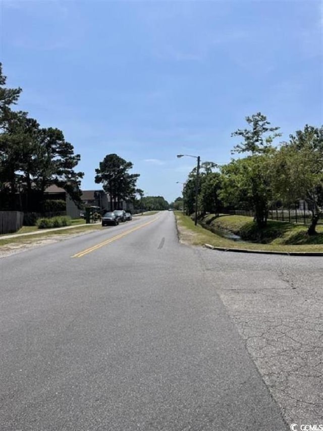 2005 Greens Blvd Unit F-205, Myrtle Beach, SC 29577 - view of asphalt street featuring street lighting, curbs, and sidewalks