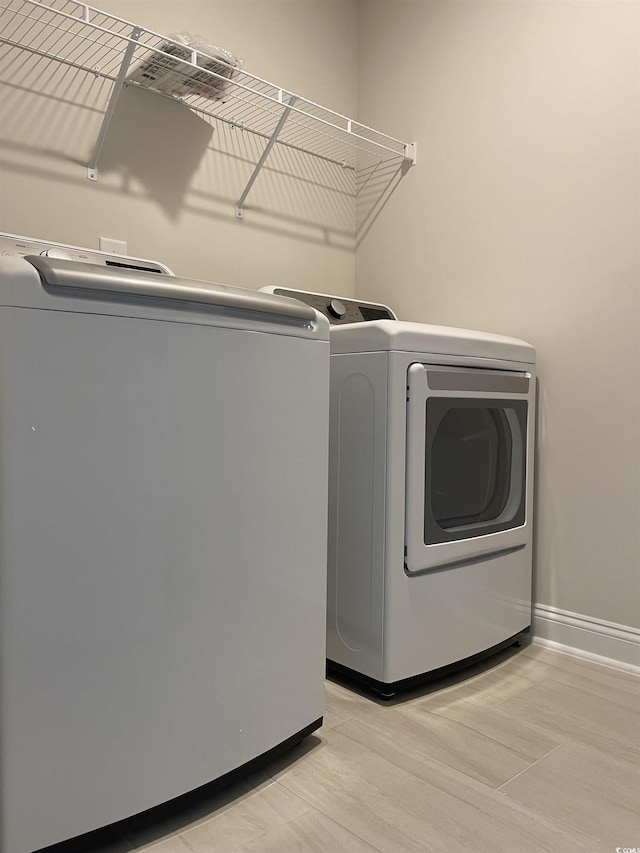3391 Moss Bridge Ln, Myrtle Beach, SC 29579 - laundry area with washer and clothes dryer, baseboards, and light wood-style floors