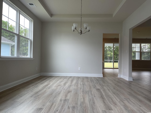 3391 Moss Bridge Ln, Myrtle Beach, SC 29579 - unfurnished room featuring a tray ceiling, healthy amount of natural light, a chandelier, and light wood finished floors