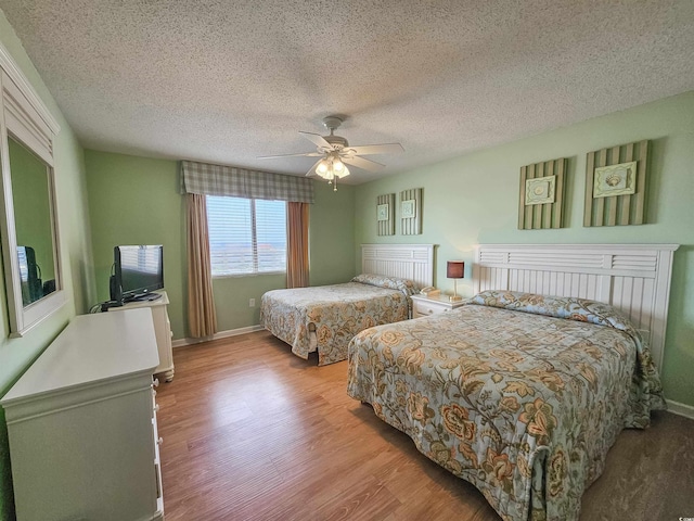 8560 Queensway Blvd Unit 508, Myrtle Beach, SC 29572 - bedroom with wood finished floors, a textured ceiling, and ceiling fan