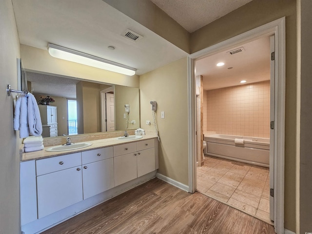 8560 Queensway Blvd Unit 508, Myrtle Beach, SC 29572 - bathroom with double vanity, wood finished floors, and shower / washtub combination