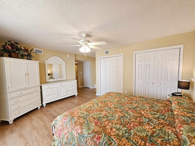 8560 Queensway Blvd Unit 508, Myrtle Beach, SC 29572 - bedroom with multiple closets, light wood finished floors, a textured ceiling, and ceiling fan