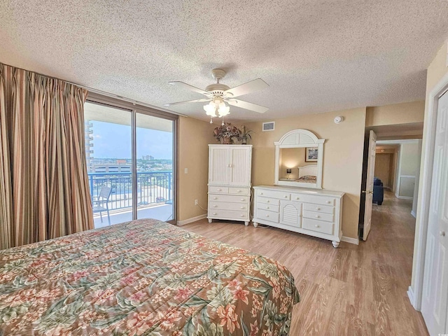 8560 Queensway Blvd Unit 508, Myrtle Beach, SC 29572 - bedroom featuring access to exterior, a textured ceiling, light wood finished floors, and ceiling fan