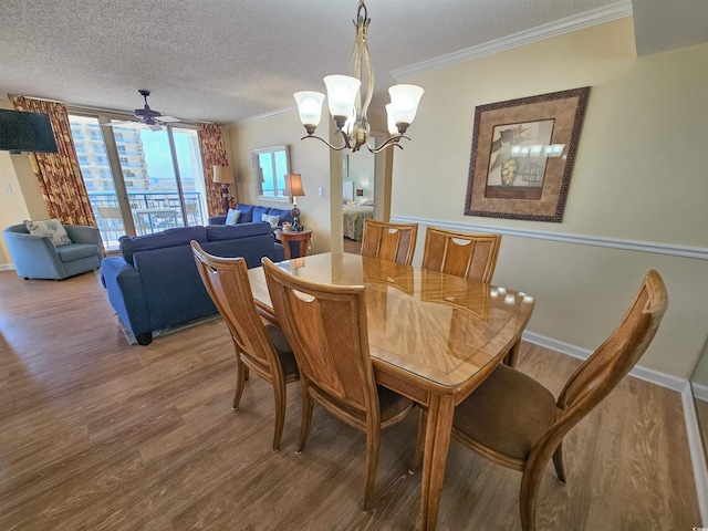 8560 Queensway Blvd Unit 508, Myrtle Beach, SC 29572 - dining area featuring wood finished floors, a chandelier, ornamental molding, and a textured ceiling