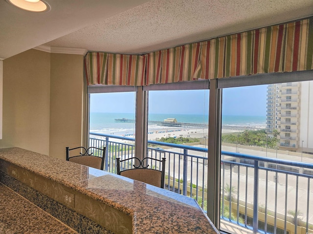 8560 Queensway Blvd Unit 508, Myrtle Beach, SC 29572 - dining area with a water view, a textured ceiling, and ornamental molding
