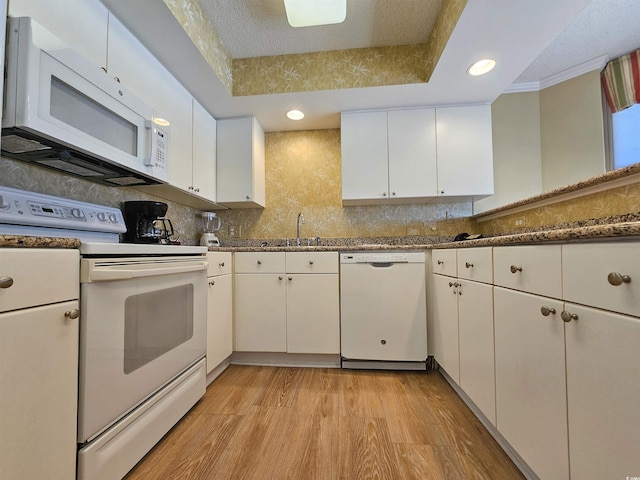 8560 Queensway Blvd Unit 508, Myrtle Beach, SC 29572 - kitchen featuring white appliances, white cabinets, a tray ceiling, recessed lighting, and light wood-type flooring