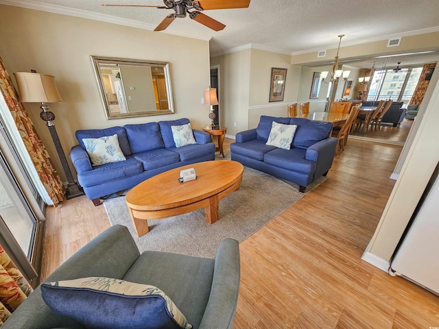 8560 Queensway Blvd Unit 508, Myrtle Beach, SC 29572 - living area featuring wood finished floors, a chandelier, crown molding, ceiling fan, and a textured ceiling