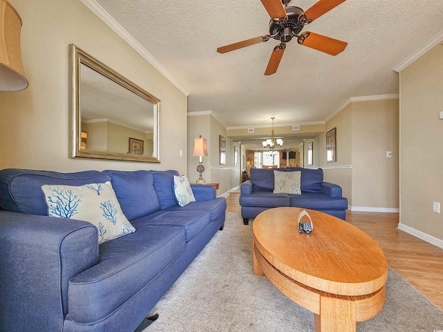 8560 Queensway Blvd Unit 508, Myrtle Beach, SC 29572 - living area with a ceiling fan, wood finished floors, a chandelier, a textured ceiling, and crown molding