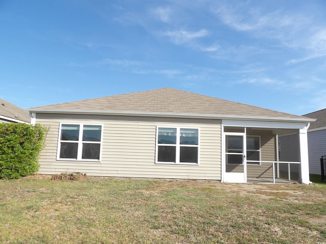 192 Mountain Ash Ln, Myrtle Beach, SC 29579 - back of property with a yard, a shingled roof, and a sunroom