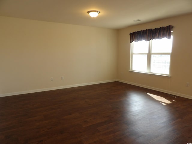 192 Mountain Ash Ln, Myrtle Beach, SC 29579 - spare room featuring dark wood-style floors and baseboards