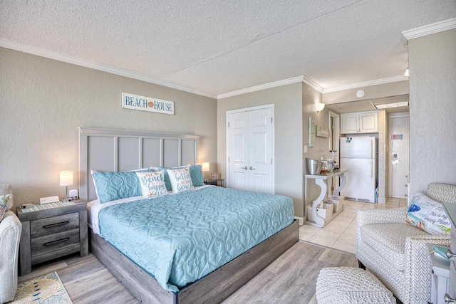 201 74th Ave N Unit 2241, Myrtle Beach, SC 29572 - bedroom with freestanding refrigerator, a textured ceiling, ornamental molding, light wood-style flooring, and a textured wall