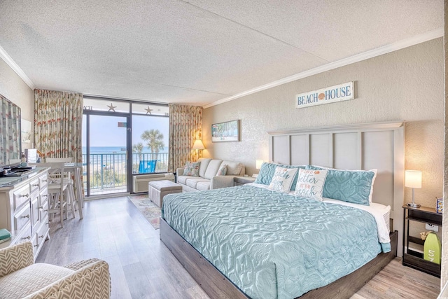 201 74th Ave N Unit 2241, Myrtle Beach, SC 29572 - bedroom with a textured ceiling, crown molding, a textured wall, wood finished floors, and access to outside