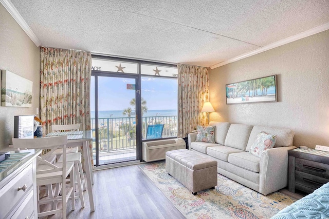 201 74th Ave N Unit 2241, Myrtle Beach, SC 29572 - living area featuring a textured wall, crown molding, a textured ceiling, wood finished floors, and a water view