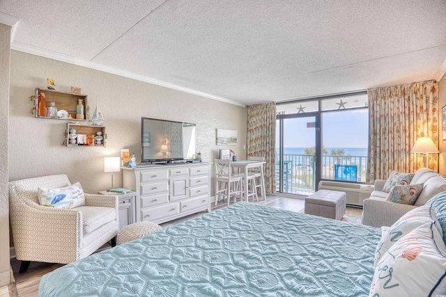 201 74th Ave N Unit 2241, Myrtle Beach, SC 29572 - bedroom with ornamental molding, a textured wall, access to outside, wood finished floors, and a textured ceiling
