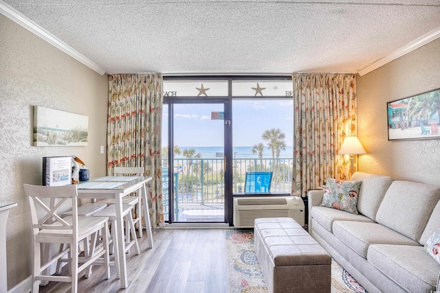 201 74th Ave N Unit 2241, Myrtle Beach, SC 29572 - living room featuring a textured wall, crown molding, a textured ceiling, wood finished floors, and a water view